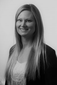 Headshot of Louise Søgaard Nielsen in black and white. Louise, a consultant at Pharma IT, is wearing a black blazer and a white dress shirt.